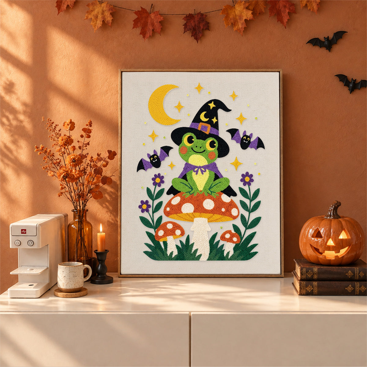 Finished Frog Witch on a Toadstool punch needle canvas on a wall