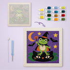 Frog Witch canvas before and after punching, with the threads and tools