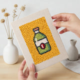 Hand holding a finished Fruit Bowl Pizza mini canvas