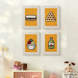 The four Fruit Bowl Pizza mini canvases on a wall above a shelf