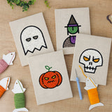 The four finished Ghost and Witch mini canvases laid out on a table