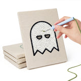 Hand punching one of the Ghost and Witch mini canvases