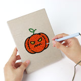 Punching a Ghost and Witch mini canvas with the punch needle