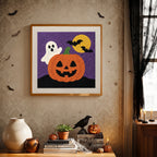 Finished Ghost Behind the Pumpkin punch needle canvas on a wall