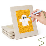 Hand punching one of the Ghost on Yellow mini canvases