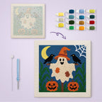 Ghost Scarecrow canvas before and after punching, with the threads and tools
