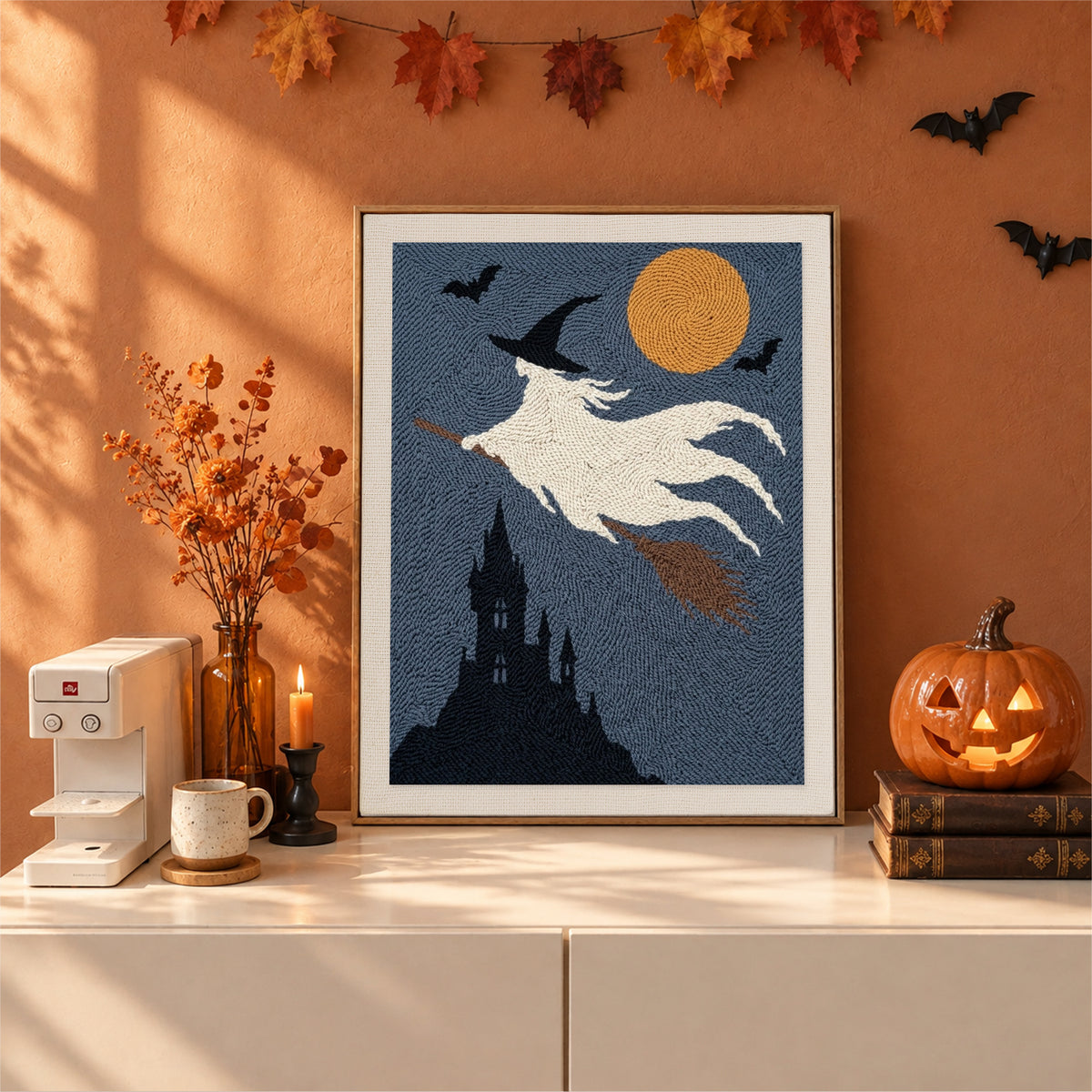 Finished Ghost Witch in Flight punch needle canvas on a wall