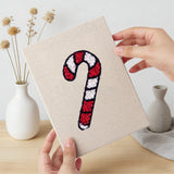Hand holding a finished Gingerbread and Wreath mini canvas