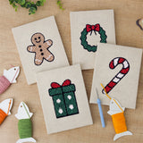 The four finished Gingerbread and Wreath mini canvases laid out on a table