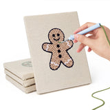 Hand punching one of the Gingerbread and Wreath mini canvases