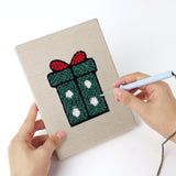 Punching a Gingerbread and Wreath mini canvas with the punch needle