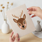 Hand holding a finished Giraffe and Deer mini canvas