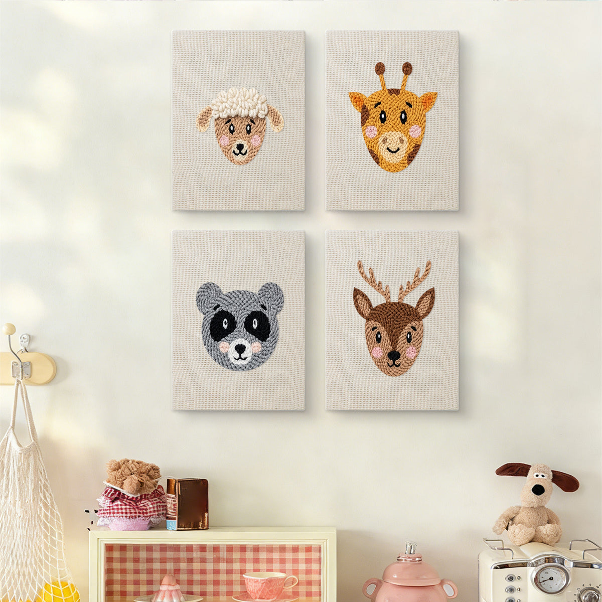 The four Giraffe and Deer mini canvases on a wall above a shelf