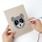 Punching a Giraffe and Deer mini canvas with the punch needle