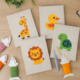 The four finished Giraffe and Turtle mini canvases laid out on a table