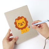Punching a Giraffe and Turtle mini canvas with the punch needle