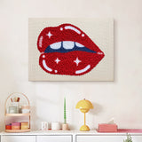 Finished Glossy Lip Bite punch needle canvas on a wall
