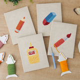 The four finished Glue Bottle Crafts mini canvases laid out on a table