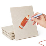 Hand punching one of the Glue Bottle Crafts mini canvases