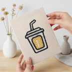 Hand holding a finished Golden Popcorn Bucket mini canvas