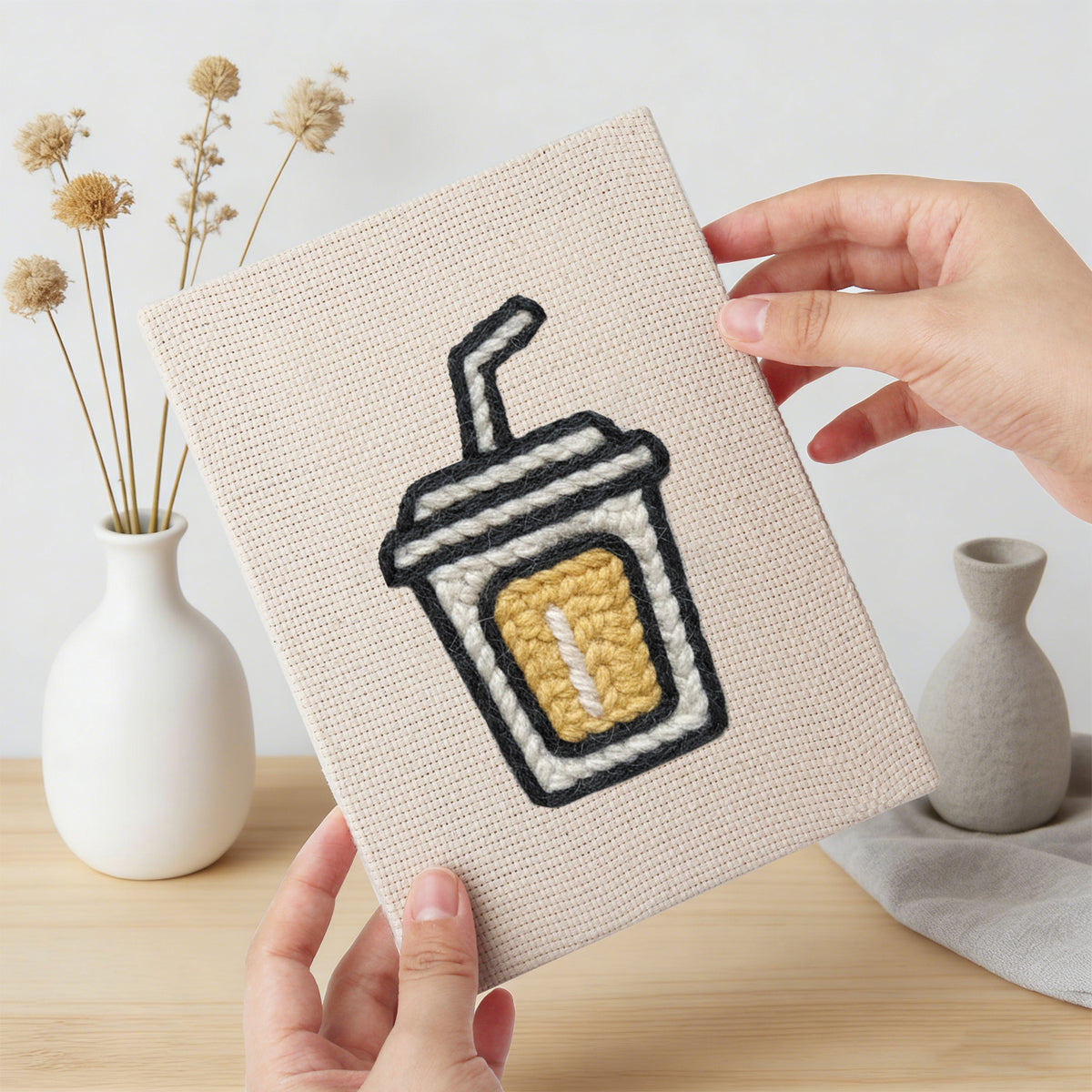 Hand holding a finished Golden Popcorn Bucket mini canvas