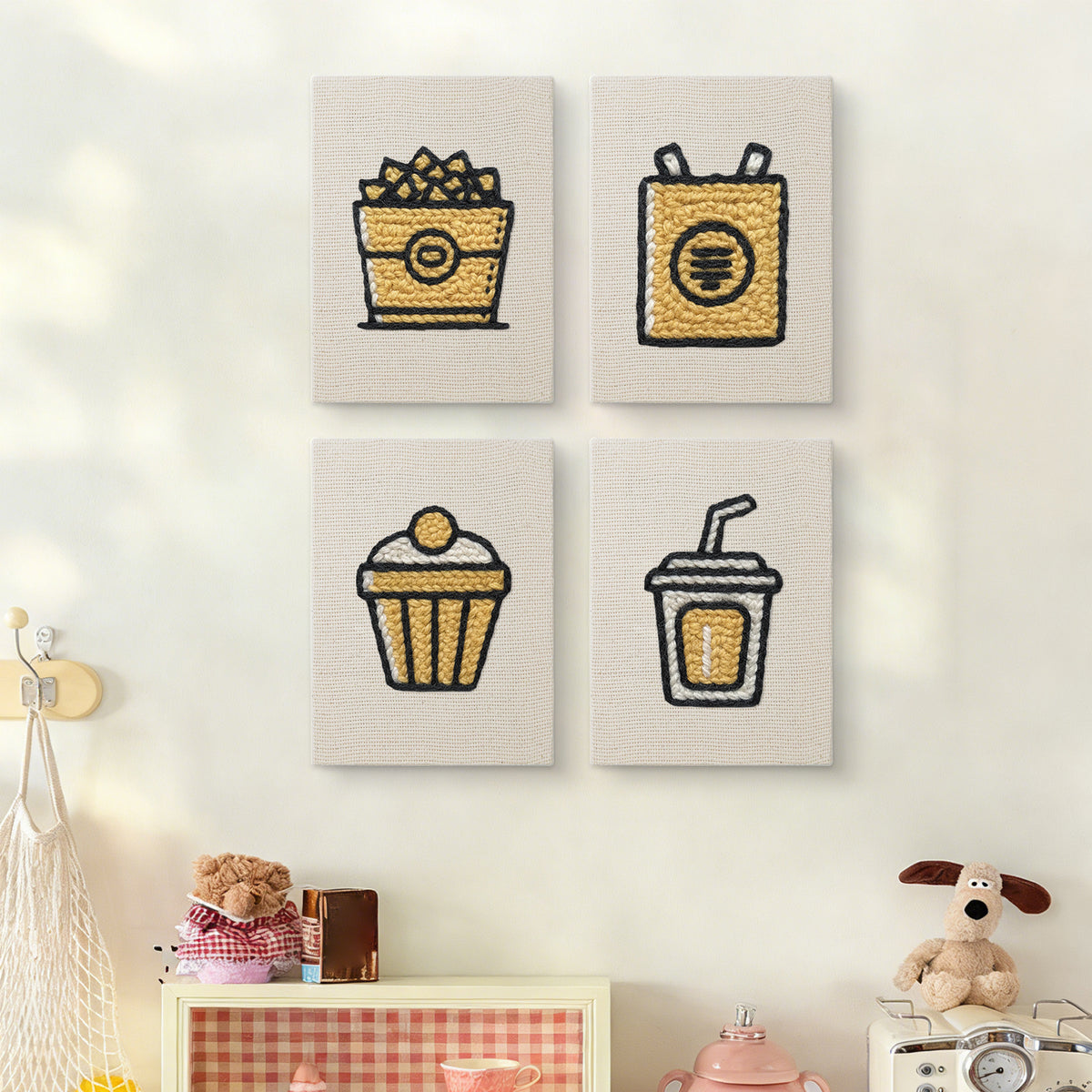 The four Golden Popcorn Bucket mini canvases on a wall above a shelf