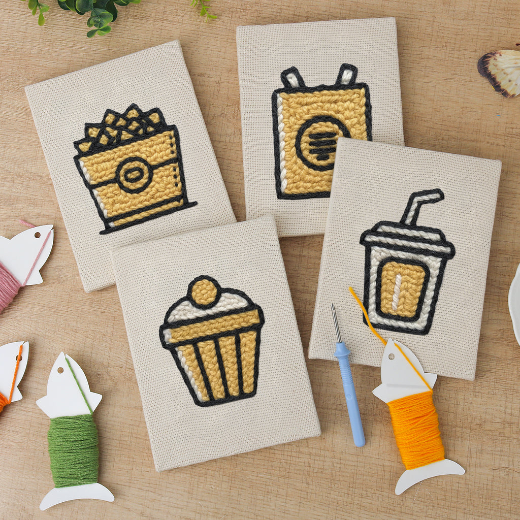 The four finished Golden Popcorn Bucket mini canvases laid out on a table