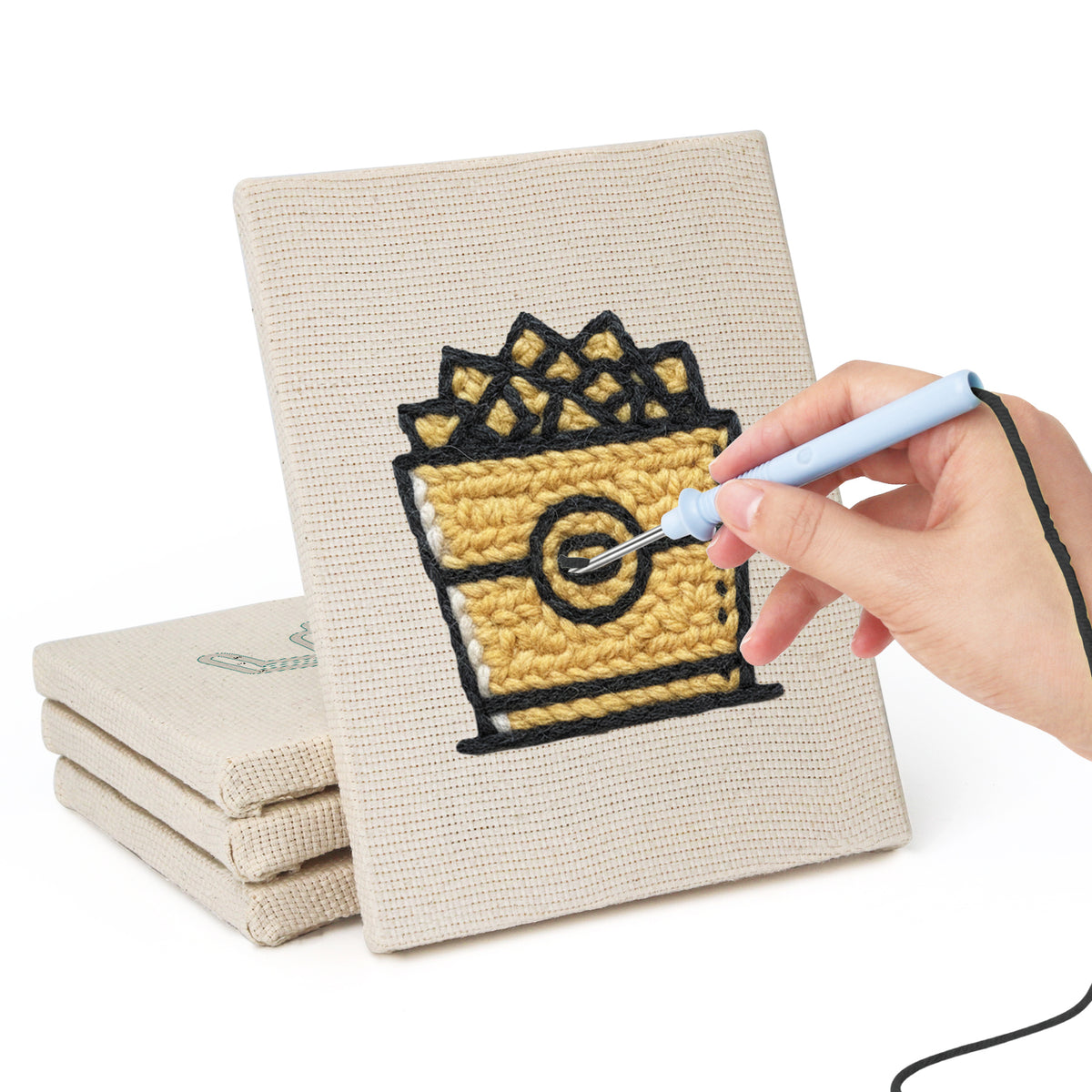 Hand punching one of the Golden Popcorn Bucket mini canvases