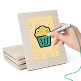 Hand punching one of the Golden Snack Time mini canvases