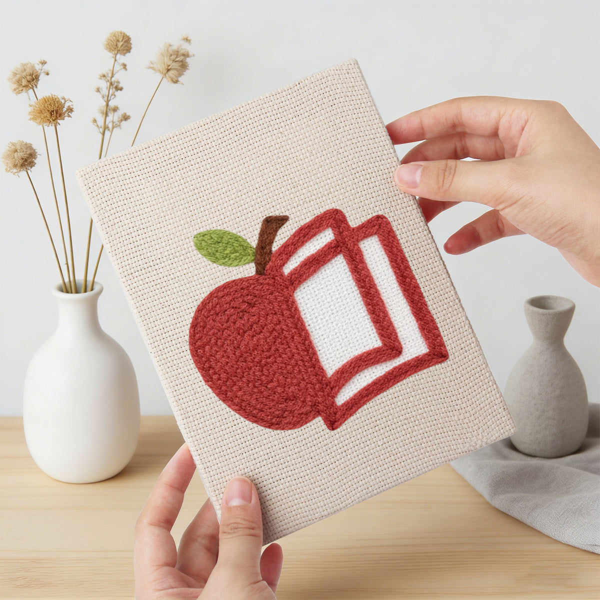Hand holding a finished Graduation Satchel mini canvas