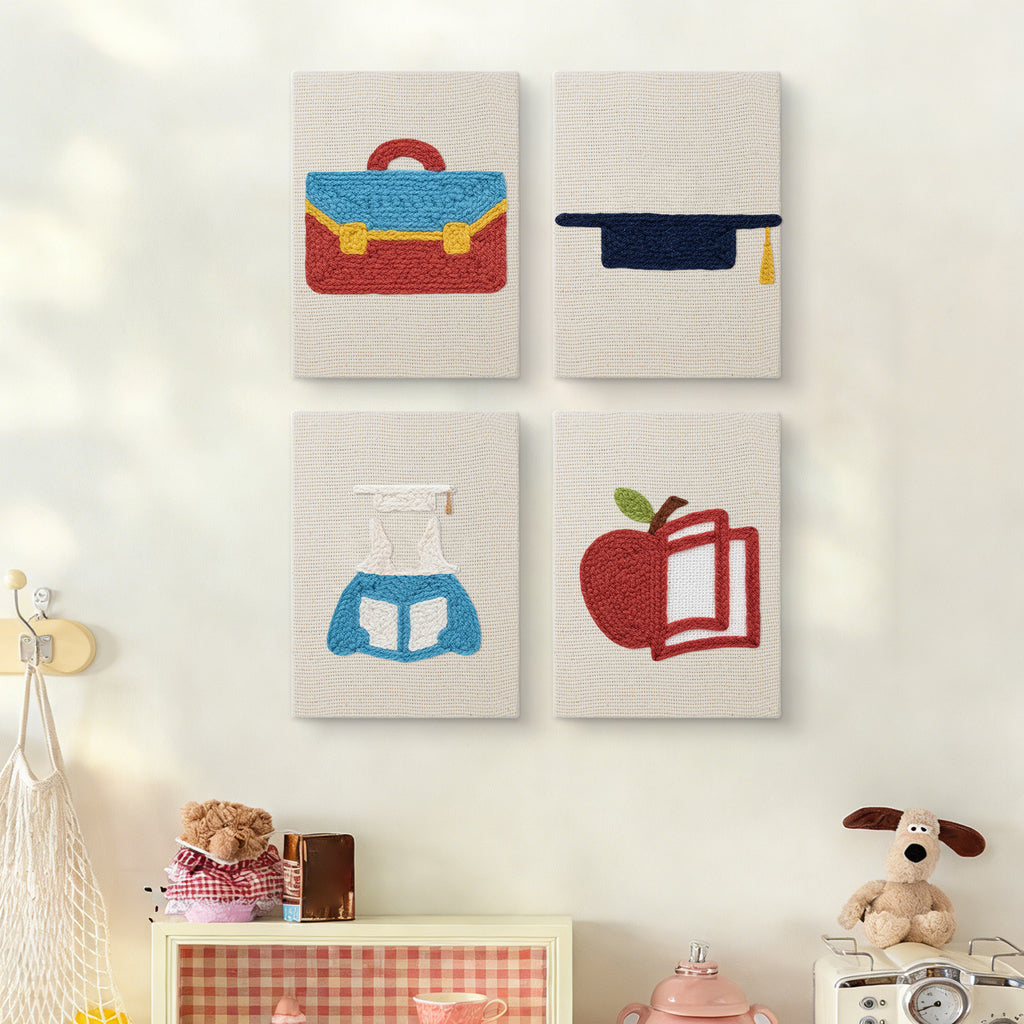 The four Graduation Satchel mini canvases on a wall above a shelf