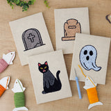 The four finished Graveyard Cat mini canvases laid out on a table