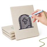 Hand punching one of the Graveyard Cat mini canvases