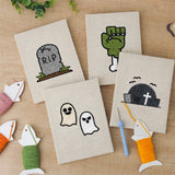 The four finished Graveyard Ghosts mini canvases laid out on a table