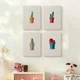 The four Gray Pot Cacti mini canvases on a wall above a shelf