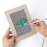 Punching a Gray Sea Friends mini canvas with the punch needle