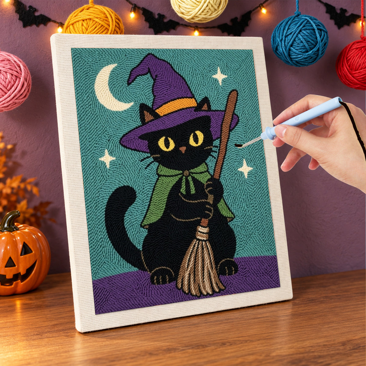 Punching the Green Cape Witch Cat design with the punch needle