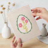 Hand holding a finished Green Egg Posies mini canvas