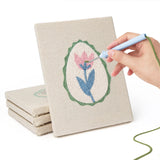 Hand punching one of the Green Egg Posies mini canvases