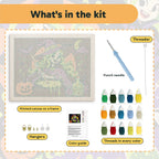 What is in the Green-Haired Potion Witch kit: printed canvas, punch needle, threader, threads, color guide and hangers