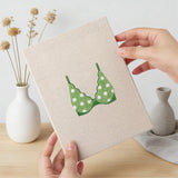 Hand holding a finished Green Polka Tops mini canvas