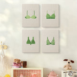 The four Green Polka Tops mini canvases on a wall above a shelf