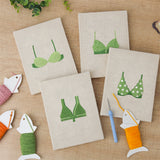 The four finished Green Polka Tops mini canvases laid out on a table