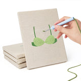 Hand punching one of the Green Polka Tops mini canvases