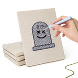 Hand punching one of the Green Skull Cauldron mini canvases