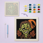 Grinning Zombie canvas before and after punching, with the threads and tools