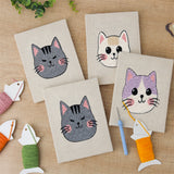 The four finished Grumpy Cat Faces mini canvases laid out on a table