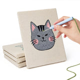 Hand punching one of the Grumpy Cat Faces mini canvases