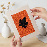 Hand holding a finished Halloween Bunting mini canvas
