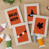 The four finished Halloween Bunting mini canvases laid out on a table